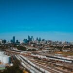 Essen i okolice: pomysły na jednodniowe wycieczki pociągiem Pociągi na torach nad rzeką w centrum miasta w słoneczny dzień